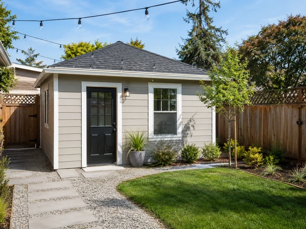 Detached backyard garage converted into a standalone ADU with new pathway