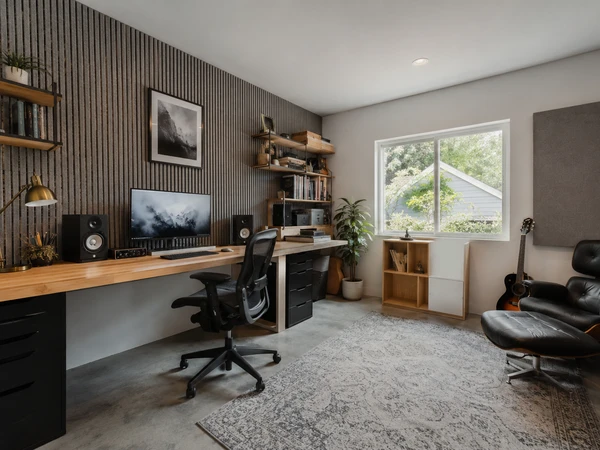 Garage converted into an insulated home office with large windows and built-in desk