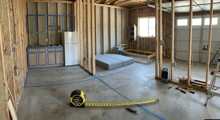 Tape measure and floor plan showing garage JADU square footage requirements in a San Jose garage